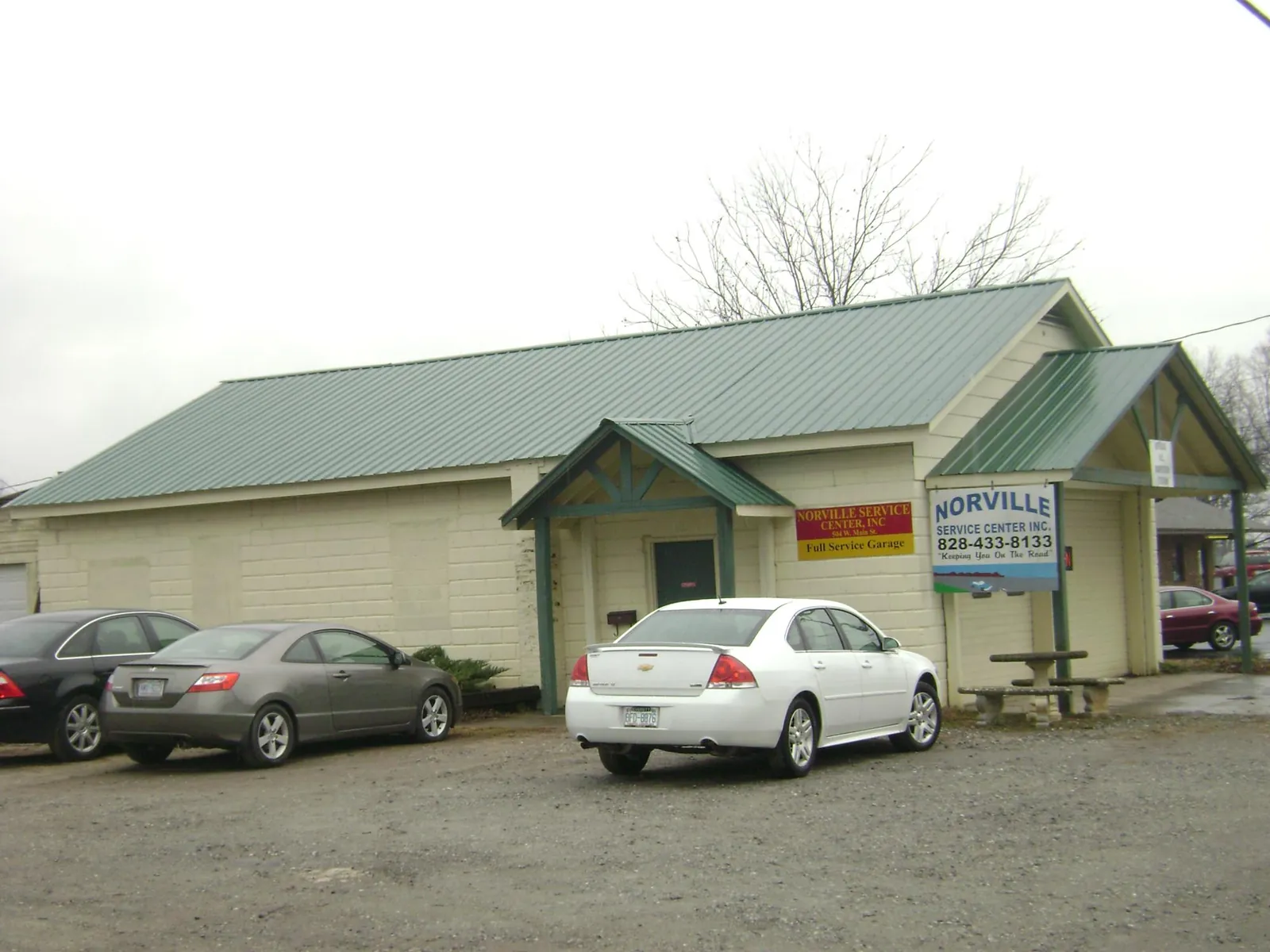 Green metal roof on a service garage with a covered entry in Collegeville